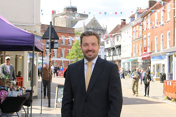 Photo of Cllr Geoff Cooper in front of the Corn Market in Romsey