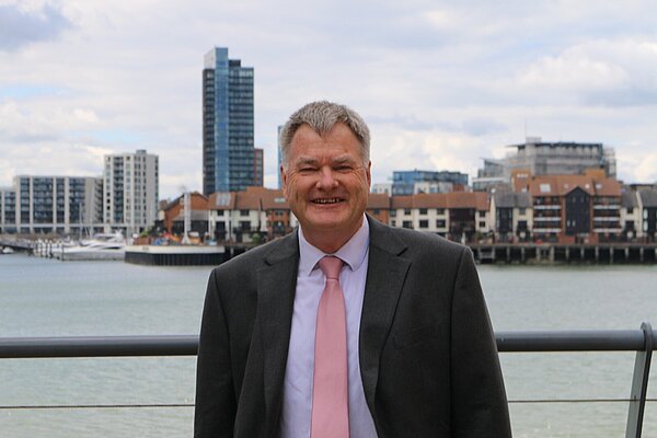 Cllr James Batho standing in front of a the River Itchen over looking Ocean Village