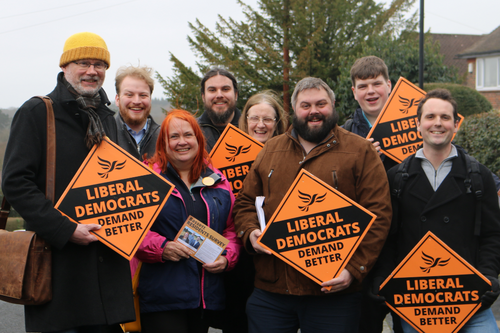 Group of people holding Liberal Democrat Signs